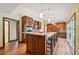 Spacious kitchen with modern appliances, granite countertops, and custom wood cabinets with a large island at 12038 Steppingstone Blvd, Tampa, FL 33635