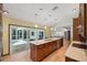 Bright kitchen with a large island, stainless steel appliances, and sliding door access to the pool at 12038 Steppingstone Blvd, Tampa, FL 33635
