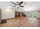 Open living space with hardwood floors, large windows, and access to kitchen and lanai, perfect for entertaining at 12038 Steppingstone Blvd, Tampa, FL 33635