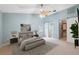 This main bedroom offers a serene retreat with high ceilings, a ceiling fan, and ensuite access at 12038 Steppingstone Blvd, Tampa, FL 33635