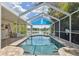 Screened-in pool overlooking the lake features a covered area offering shade for relaxing and enjoying the water view at 12038 Steppingstone Blvd, Tampa, FL 33635