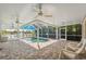 Screened-in pool area with brick pavers, ceiling fans and view of the lake at 12038 Steppingstone Blvd, Tampa, FL 33635
