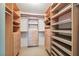 Well-organized walk-in closet with custom shelving and drawers provides ample storage space at 12038 Steppingstone Blvd, Tampa, FL 33635