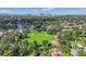 Aerial view of the neighborhood near green space and playgrounds with Tampa skyline in the distance at 1217 E 29Th Ave, Tampa, FL 33605