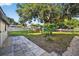 Expansive backyard with mature trees, partial fencing, and a stone patio for outdoor living at 1217 E 29Th Ave, Tampa, FL 33605