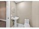 Bathroom featuring pedestal sink, toilet, and marble floors at 1217 E 29Th Ave, Tampa, FL 33605