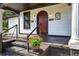 Beautiful craftsman home with a welcoming red front door and a lovely porch at 1217 E 29Th Ave, Tampa, FL 33605