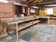 Garage interior featuring workbenches, storage shelves, and pegboard for tool organization at 1217 E 29Th Ave, Tampa, FL 33605