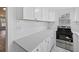 Kitchen featuring new stainless steel range and white cabinets, with gray quartz countertop at 1217 E 29Th Ave, Tampa, FL 33605