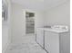 Bright laundry room with a side-by-side washer and dryer and a window offering plenty of natural light at 1217 E 29Th Ave, Tampa, FL 33605