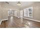Open living room features laminate floors, arched entryways, with many windows offering plenty of natural light at 1217 E 29Th Ave, Tampa, FL 33605