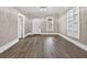 Open living room features laminate floors, built-in shelving, archway, and a neutral color palette at 1217 E 29Th Ave, Tampa, FL 33605
