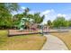 Community playground featuring multiple slides, climbing structures, and a secure fenced perimeter for safety and enjoyment at 1217 E 29Th Ave, Tampa, FL 33605