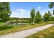 Picturesque pond view with a bench seat, creating a serene and relaxing community space at 1217 E 29Th Ave, Tampa, FL 33605