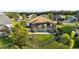 Aerial view of the property highlights a screen lanai, pool, lush lawn, and tropical landscaping at 12830 24Th Street E Cir, Parrish, FL 34219
