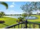 Scenic backyard view showcases lush greenery, a tranquil pond and verdant tropical landscaping at 12830 24Th Street E Cir, Parrish, FL 34219