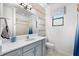 Bright bathroom featuring a large mirror and a decorative blue vanity at 12830 24Th Street E Cir, Parrish, FL 34219