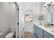 Well-lit bathroom featuring double sinks, modern fixtures, and a walk-in shower at 12830 24Th Street E Cir, Parrish, FL 34219