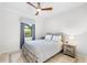 Cozy bedroom featuring a ceiling fan and a window offering a view of the outdoors at 12830 24Th Street E Cir, Parrish, FL 34219