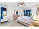 Bright bedroom with natural wood accents, including a dresser and bedframe, plus two sunny windows at 12830 24Th Street E Cir, Parrish, FL 34219