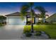 Charming single-story home with a well-manicured lawn and inviting curb appeal at dusk at 12830 24Th Street E Cir, Parrish, FL 34219