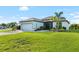 Inviting single-story home with a lush green lawn and a well-manicured garden in the front yard at 12830 24Th Street E Cir, Parrish, FL 34219