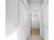 Bright hallway leads to a bathroom with neutral tile and double closets for ample storage at 12830 24Th Street E Cir, Parrish, FL 34219
