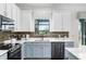 Modern kitchen showcases white countertops, a stylish backsplash, and stainless steel appliances at 12830 24Th Street E Cir, Parrish, FL 34219