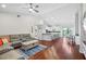 Bright and open living space with hardwood floors flowing into a modern kitchen and dining area at 12830 24Th Street E Cir, Parrish, FL 34219