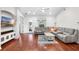 Cozy living room with hardwood floors, a sectional sofa, and a decorative console with mounted television at 12830 24Th Street E Cir, Parrish, FL 34219
