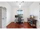 Well-lit home office with wood floors and a large window view at 12830 24Th Street E Cir, Parrish, FL 34219