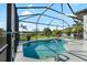 Screened-in pool with a view of the lake and lush landscaping at 12830 24Th Street E Cir, Parrish, FL 34219