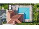 Aerial view of the community swimming pool with ample seating, clubhouse, and accessible parking at 12830 24Th Street E Cir, Parrish, FL 34219