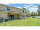 Exterior view of the rear of the home with a covered patio and grassy backyard at 12841 Buffalo Run Dr, Gibsonton, FL 33534