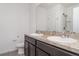 Bathroom featuring double sinks, dark wood cabinets, and a glass door shower at 12841 Buffalo Run Dr, Gibsonton, FL 33534