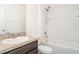 Bathroom features a shower and tub combination, large mirror, and a single sink vanity at 12841 Buffalo Run Dr, Gibsonton, FL 33534
