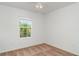 Bedroom featuring a ceiling fan, carpeted floor, and window with a view to the green trees at 12841 Buffalo Run Dr, Gibsonton, FL 33534