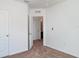 Bedroom features neutral carpeting, white walls and trim, and an open door to the ensuite at 12841 Buffalo Run Dr, Gibsonton, FL 33534