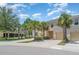 Exterior of a townhouse showcasing well-maintained landscaping, driveway, and a glimpse of the neighborhood at 12841 Buffalo Run Dr, Gibsonton, FL 33534