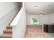 View of the living room and stairs with carpeted floor and sliding glass door to back yard at 12841 Buffalo Run Dr, Gibsonton, FL 33534