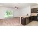 Spacious living room with sliding glass doors and an adjacent kitchen area with granite countertops at 12841 Buffalo Run Dr, Gibsonton, FL 33534
