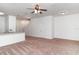 Bright living room featuring carpet, ceiling fan, and an open layout, providing a welcoming space at 12841 Buffalo Run Dr, Gibsonton, FL 33534