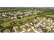 Aerial view featuring the home with a screened enclosure and golf course in the neighborhood at 13003 Carlington Ln, Riverview, FL 33579