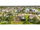 Aerial view showcasing the home, neighborhood, and a pond in the distance at 13003 Carlington Ln, Riverview, FL 33579