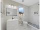 Modern bathroom featuring a white vanity, sleek fixtures, and a tiled walk-in shower with decorative niche at 13003 Carlington Ln, Riverview, FL 33579