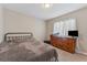 Neutral bedroom with comfortable bedding and dark wood dresser at 13003 Carlington Ln, Riverview, FL 33579