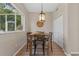 Bright dining area features a wooden table with stylish chairs and a pendant light fixture at 13003 Carlington Ln, Riverview, FL 33579