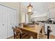 Cozy dining area showcasing a wood table with seating and an elegant pendant light at 13003 Carlington Ln, Riverview, FL 33579