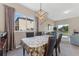 Well-lit dining area featuring modern light fixture and views of the exterior scenery at 13003 Carlington Ln, Riverview, FL 33579