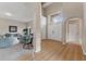 Bright foyer with wood floors leads into the living room with neutral decor and a transom window at 13003 Carlington Ln, Riverview, FL 33579
